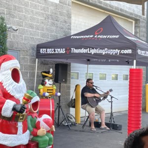 Santa Claus inflatable decoration with Christmas music celebration.