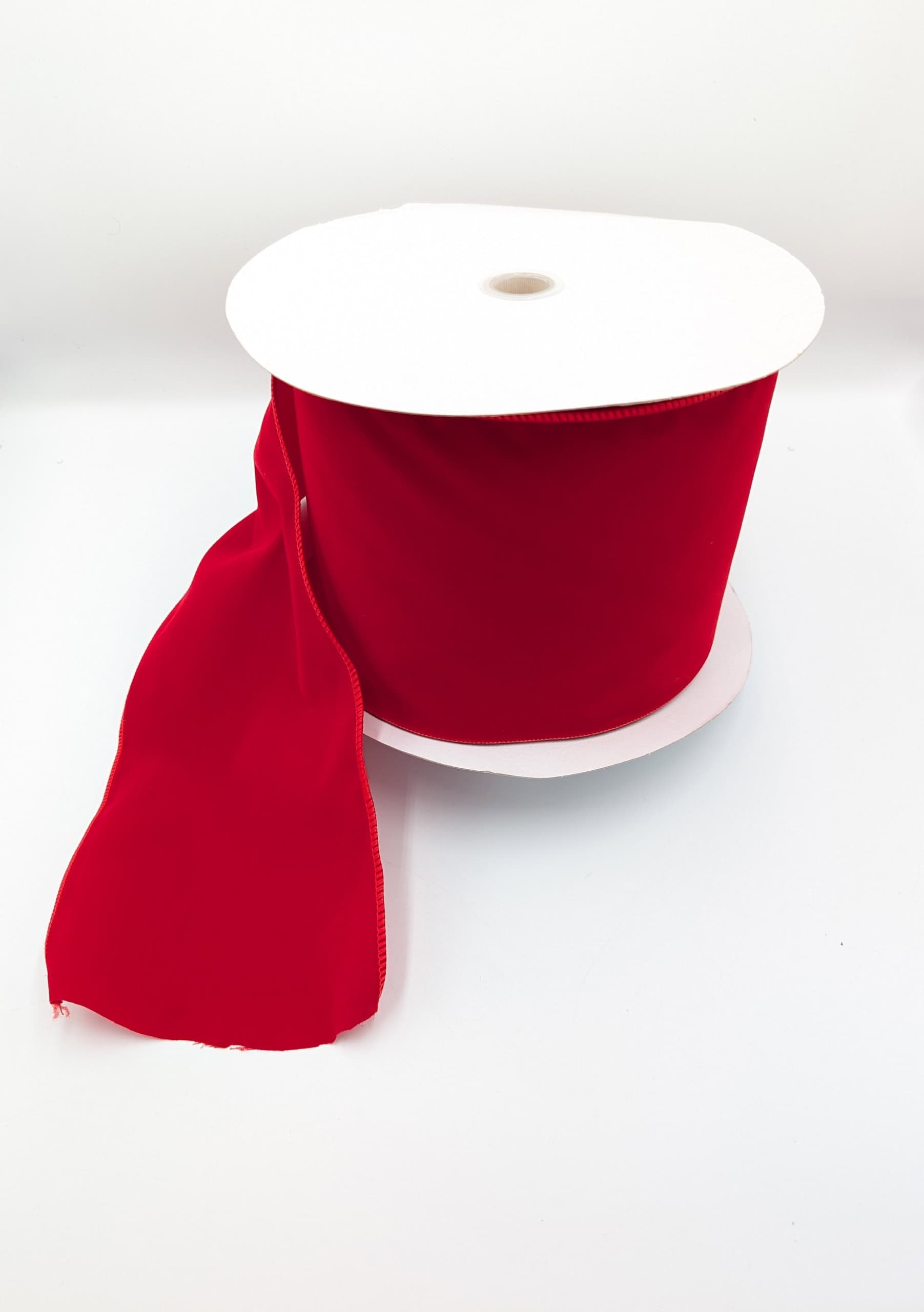 Red Christmas ribbon on white background.