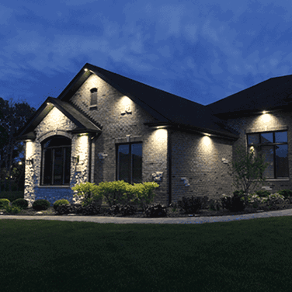 Bright outdoor LED lighting illuminating a residential house at night.